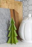 Green paper Christmas tree decor on the counter in the kitchen.