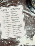Black writing on a printable baking substitutions chart on a four dusted surface is one of the cooking charts in the set of 3.