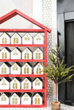Scandinavian inspired Christmas advent calendar next to a modern Christmas tree decor.