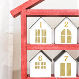 Close-up of the wooden house shaped shelves with paper houses on it.
