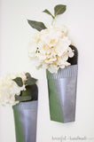 Close up view of the hammered metal spray paint on the wall vases.