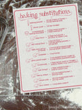 Printable ingredient substitutions chart on a floured table.