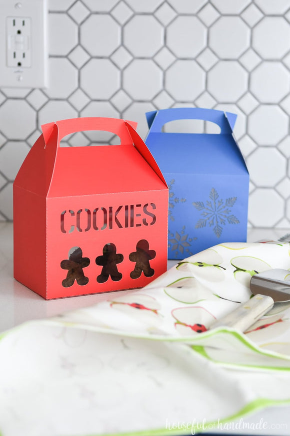 Red gingerbread cookie gift box and blue snowflake cookie box for packaging cookies for Christmas.
