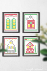 Wall with 4 Christmas printables in frames hanging on it.