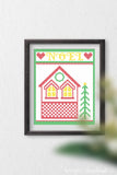 Cross-stitch house with a frame and Noel around it as printable Christmas art.