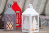 Paper Christmas decor of 3 paper lanterns with different colors and window designs.
