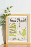 Fresh market pears farmers market sign in a frame next to a vase.