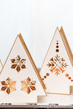 Close-up photo of 2 of the Christmas tree shaped paper lanterns with Nordic designs on them.