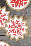 Close-up shot of the cross-stitched snowflake design on the Nordic paper ornaments.