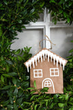 Paper gingerbread house ornament with icicle decoration.