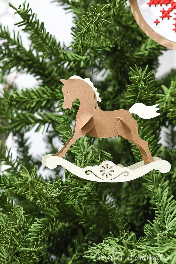 Close up photo of the paper rocking horse Christmas ornament.