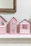 Paper Christmas village with Scandinavian inspired house designs with cross-stitched patterns on them.
